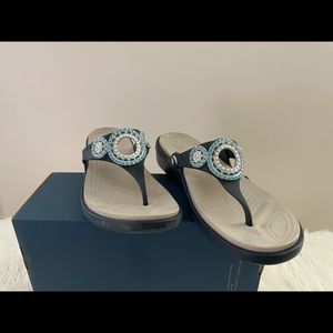 Croc sandals with heel and decorative medallion